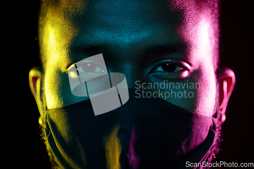 Image of african american man wearing black reusable mask