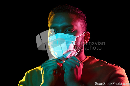 Image of african american man wearing medical mask