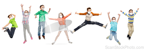 Image of children in face protective masks jumping in air