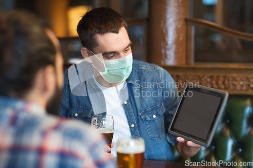 Image of men in masks with tablet pc drink beer at bar