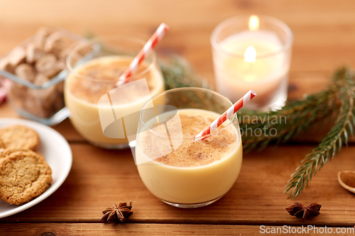 Image of glasses of eggnog, oatmeal cookies and fir branch