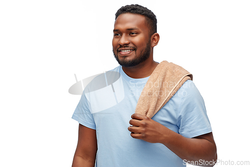Image of smiling african american young man with bath towel