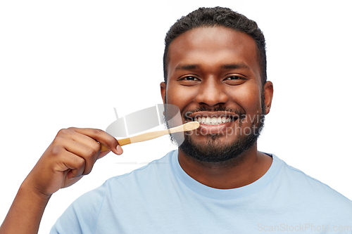 Image of smiling african man with toothbrush cleaning teeth