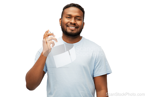 Image of happy african american man with perfume