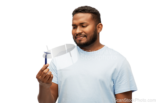 Image of african american man holding razor blade