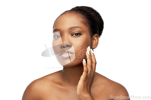 Image of portrait of african woman touching her face