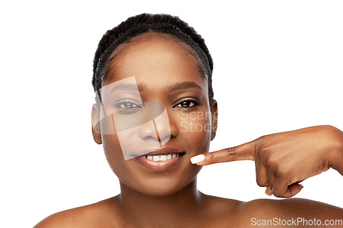 Image of african american woman pointing to her mouth
