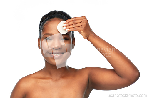 Image of african woman cleaning face with cotton pad