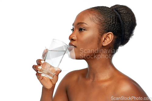 Image of young african american woman with glass of water