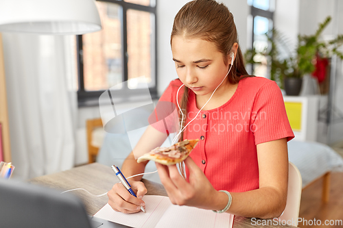 Image of student girl in earphones with pizza at home