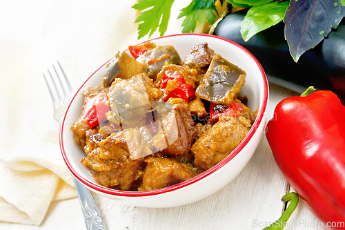 Image of Meat with eggplant and pepper in bowl on table