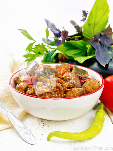 Image of Meat with eggplant and pepper in bowl on white board