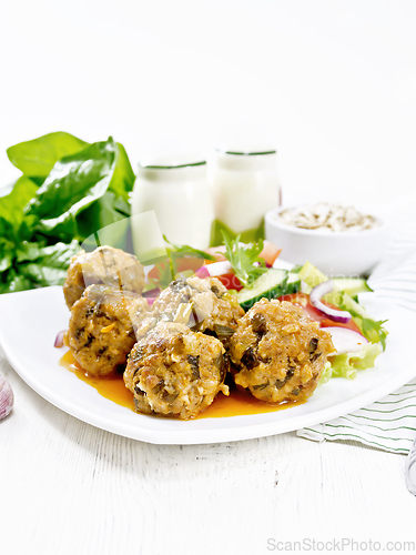 Image of Meatballs with spinach and oatmeal on white board