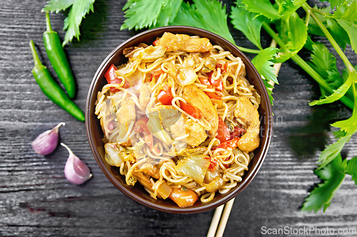 Image of Noodles with cabbage and chicken in bowl on board top