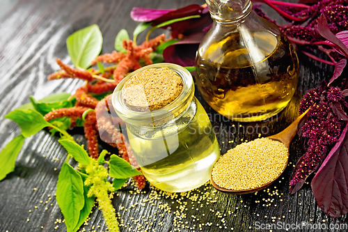 Image of Oil amaranth in jar on wooden board