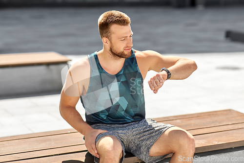 Image of man with fitness tracker in city