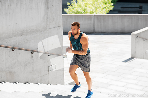 Image of young man running upstairs