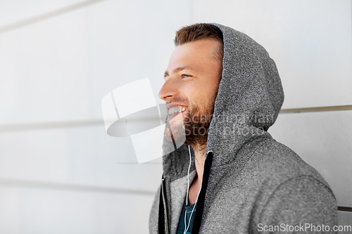 Image of man in earphones listening to music outdoors