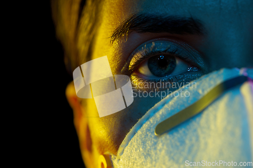 Image of young woman wearing protective mask or respirator