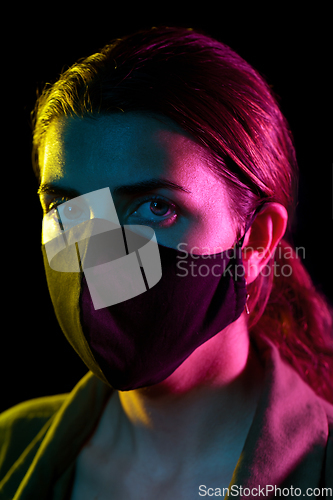 Image of young woman wearing reusable protective mask