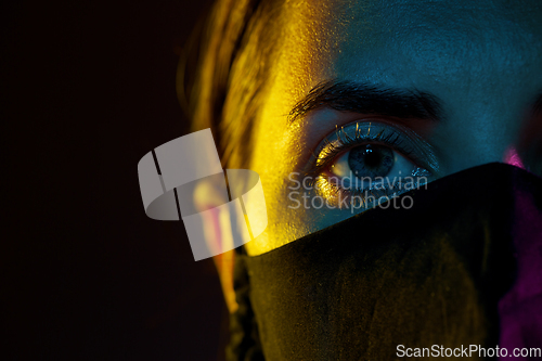 Image of young woman wearing reusable protective mask