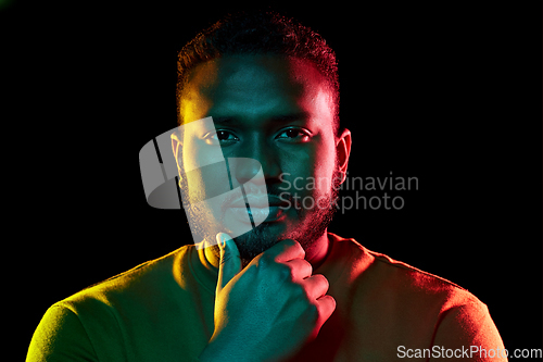 Image of young african american man over black background