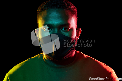 Image of african american man wearing black reusable mask