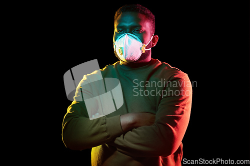 Image of african american man in mask or respirator