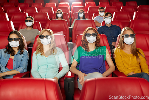 Image of people in masks watching movie in theater