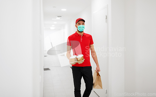 Image of delivery man in mask with coffee and food