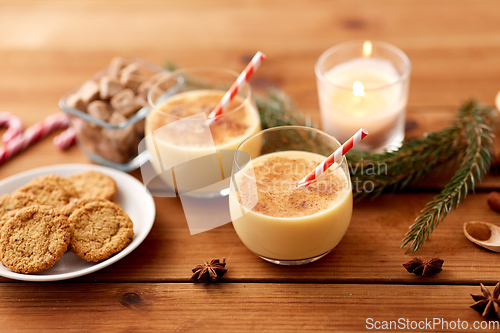 Image of glasses of eggnog, oatmeal cookies and fir branch