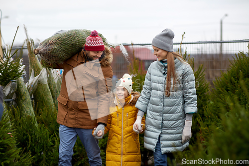 Image of happy family buying christmas tree at market