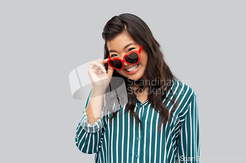 Image of happy asian woman with in heart shaped sunglasses