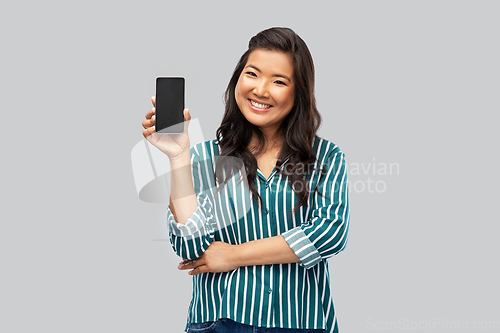 Image of happy asian woman over grey background