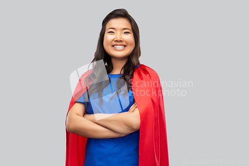 Image of happy asian woman in red superhero cape