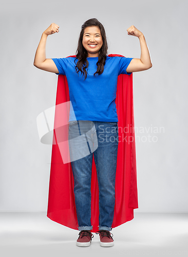 Image of happy asian woman in red superhero cape