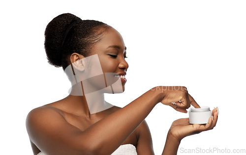 Image of smiling african american woman with moisturizer