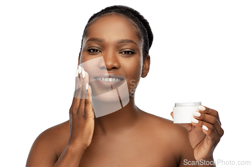 Image of smiling african american woman with moisturizer