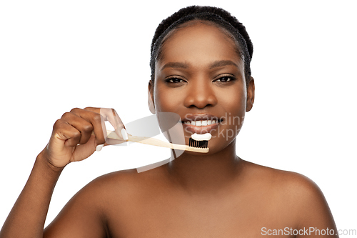 Image of african woman cleaning teeth with toothbrush