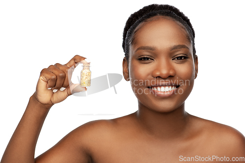 Image of african american woman with gold mask in bottle