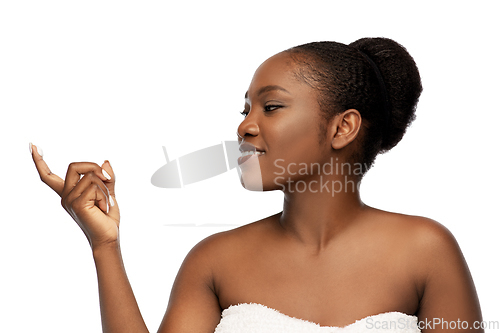 Image of smiling african american woman with moisturizer