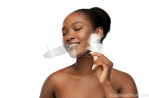 Image of happy african american woman with feather