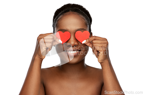 Image of smiling african american woman with red hearts