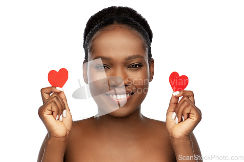 Image of smiling african american woman with red hearts