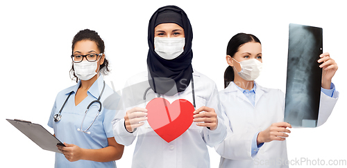 Image of group of female doctors in masks with stethoscopes