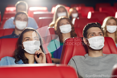 Image of people in masks watching movie in theater