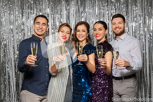 Image of happy friends toasting champagne glasses at party