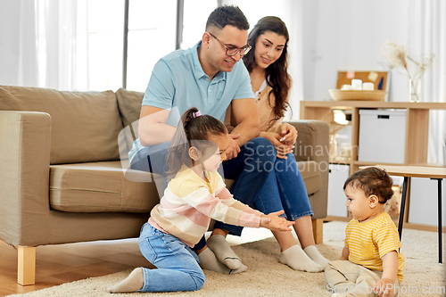 Image of portrait of happy family sitting on sofa at home
