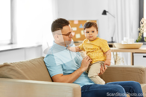 Image of happy father with little baby son at home