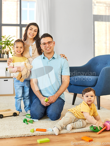 Image of happy family palying with wooden toys at home